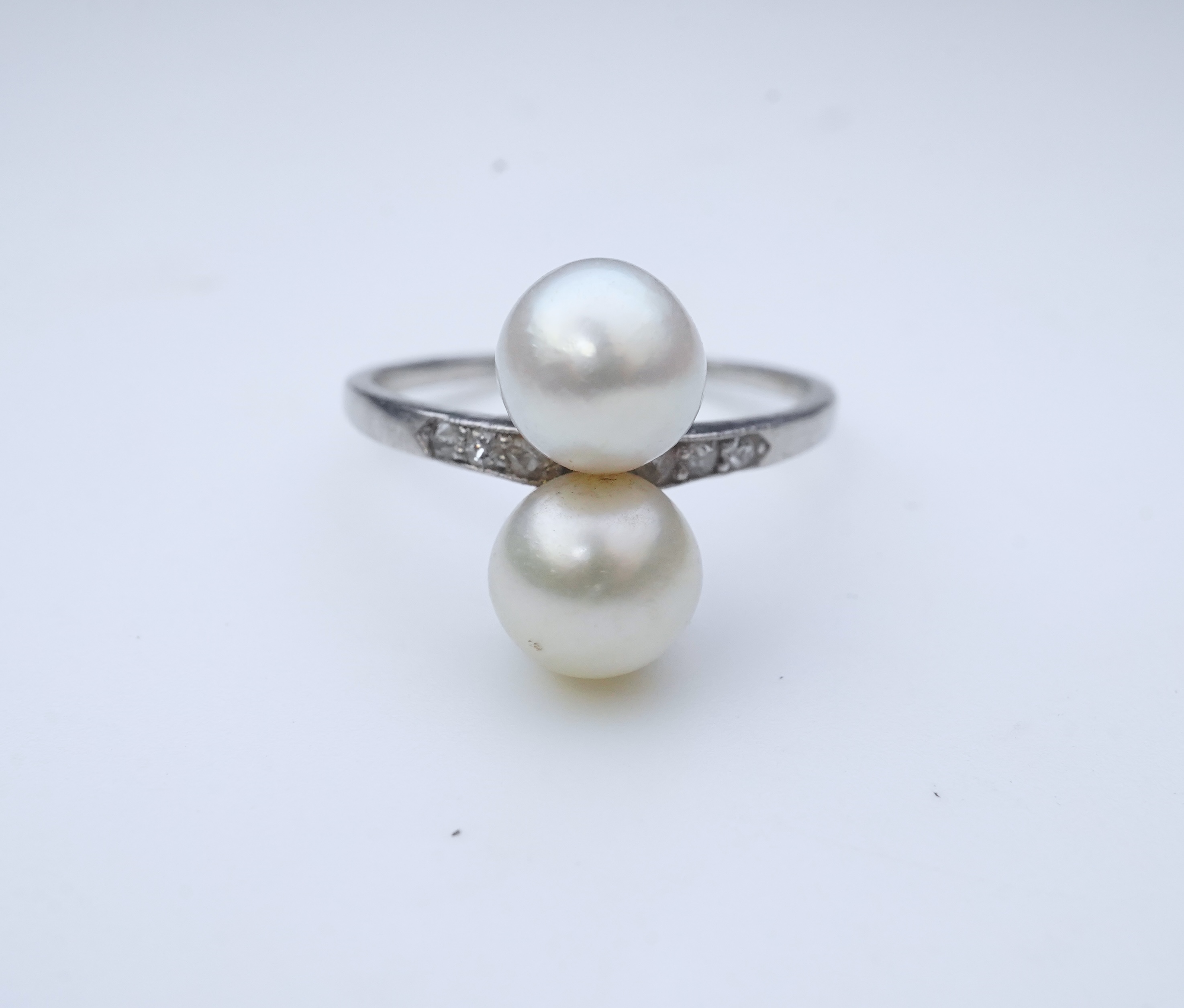 A pearl and diamond toi-et-moi ring, circa 1920